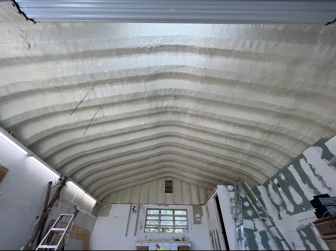 Spray polyurethane foam applied to the underside of a metal roof deck in East Lansing